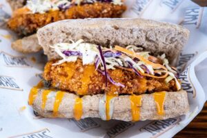 Delicious crispy chicken sandwich topped with fresh coleslaw and sauce, perfect for a quick meal.